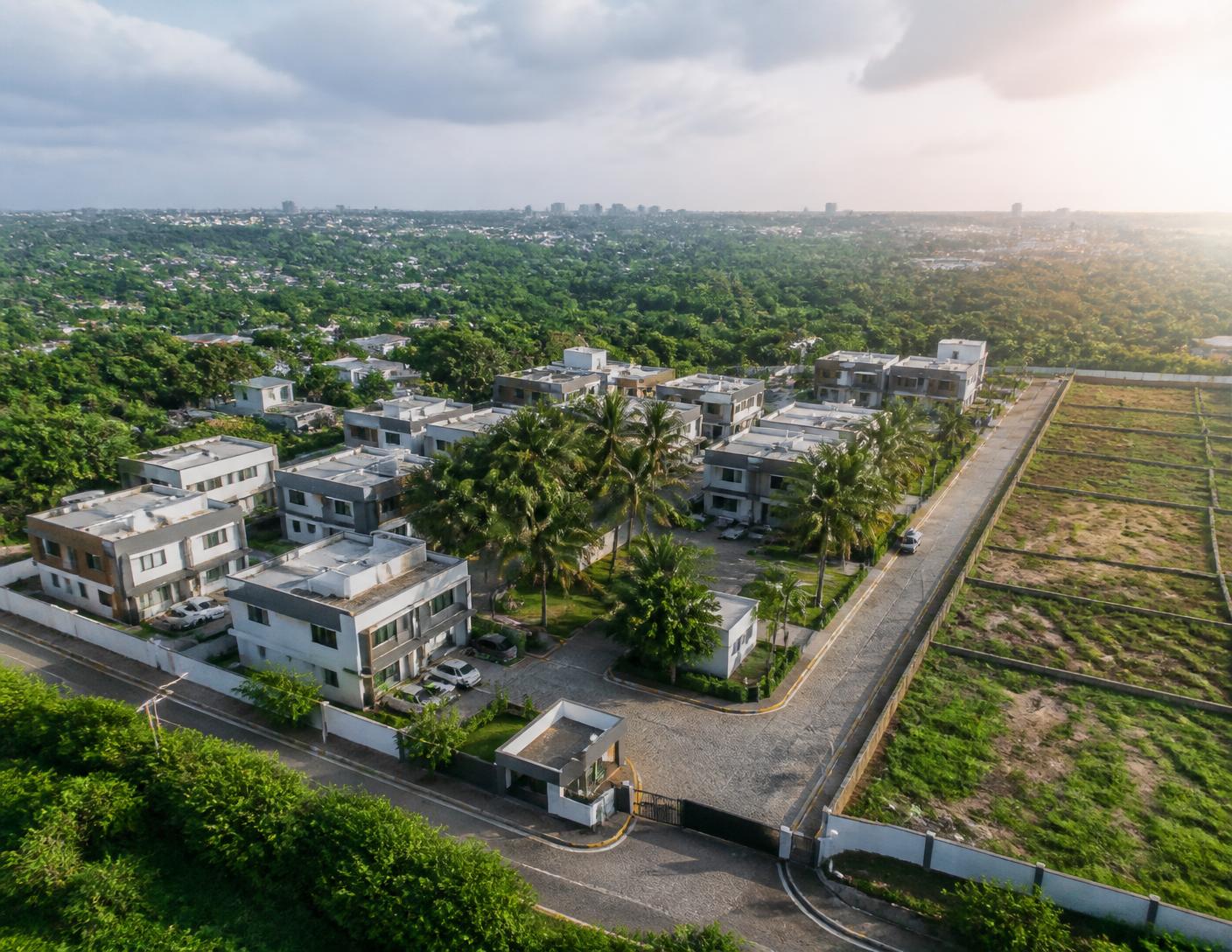 Aerial view of a premium master-planned estate with completed homes and surveyed plots